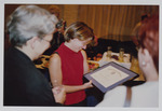 Maria Ortiz admires her scholarship certificate by Women's Studies Center, Florida International University