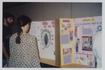 Women's Studies Student Conference attendees read student poster boards by Women's Studies Center, Florida International University